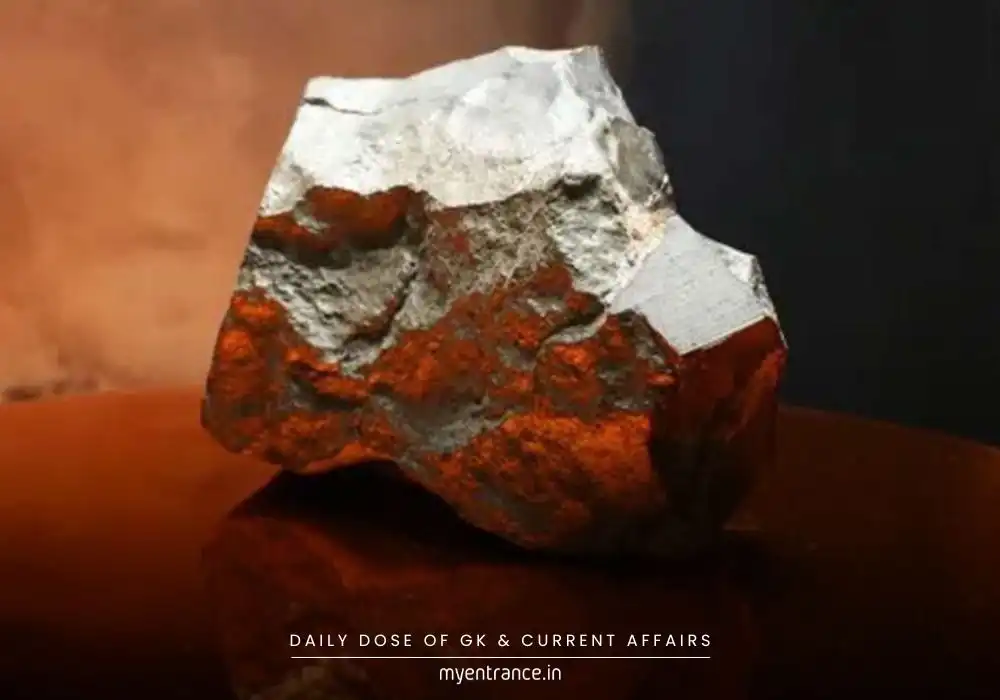 Martian meteorite NWA 16788 displayed at Sotheby's auction, a dark volcanic rock from Mars with fusion crust.