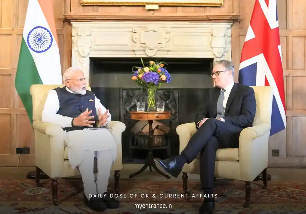 Indian and UK flags waving together symbolizing the newly signed Free Trade Agreement (FTA), Prime Minister Narendra Modi and UK PM Keir Starmer shaking hands.