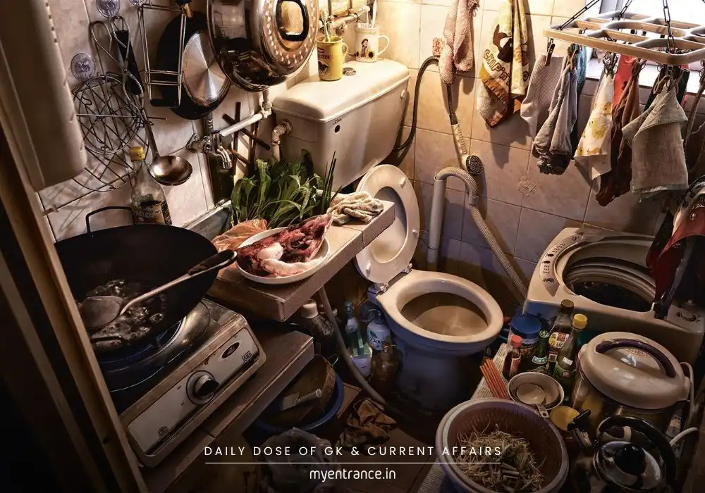 A cramped Hong Kong coffin cubicle with a small bed, kitchen, and toilet in one tiny space, highlighting extreme housing struggles.
