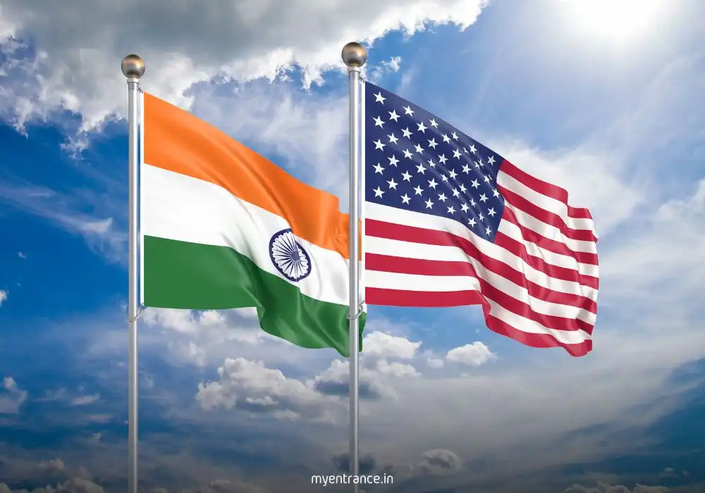 Indian and American diplomats shaking hands against flags, symbolizing resilient bilateral relations amidst trade tensions